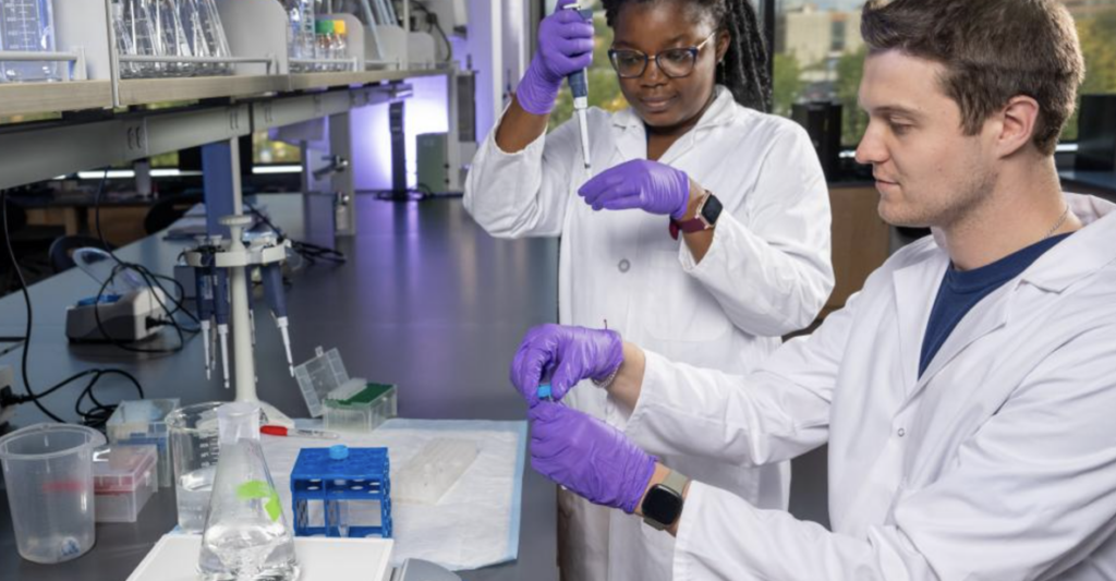 Two Students measuring with pipettes